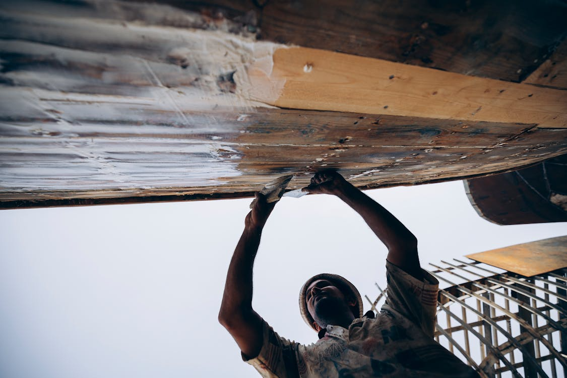 An image of a man working on a roof