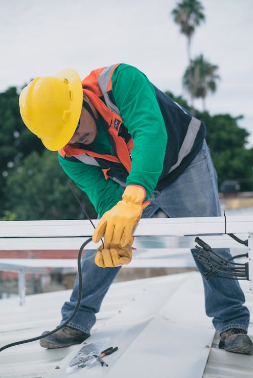 An image of a roofer working on a roof