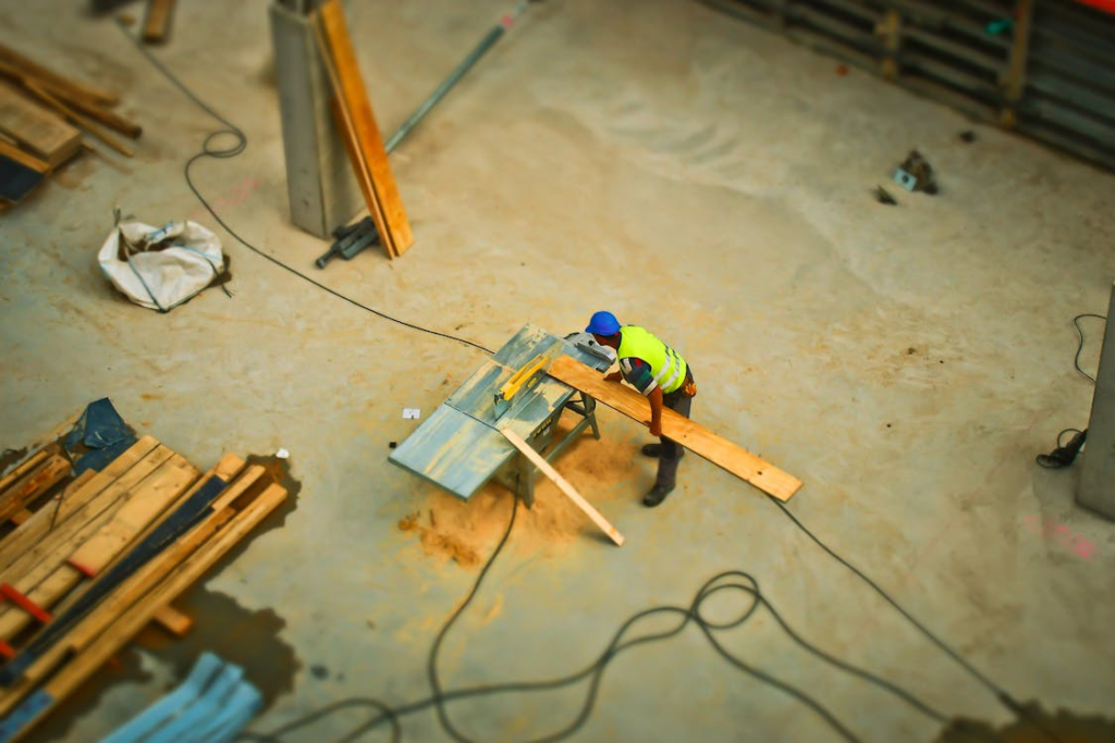 An image of a person cutting material on a table