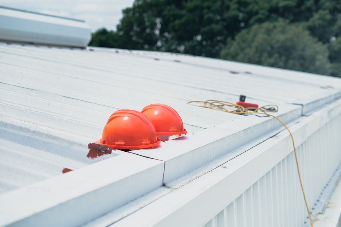An image of red helmets on a white roof