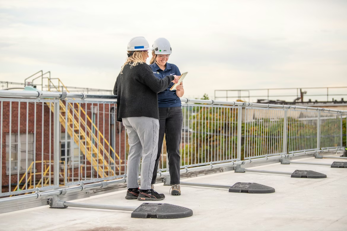 people on top of a building for a roof inspection