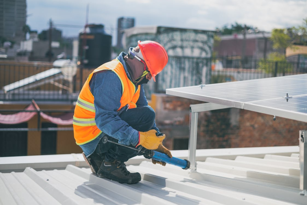 a person on top of a roof working on roof maintenance