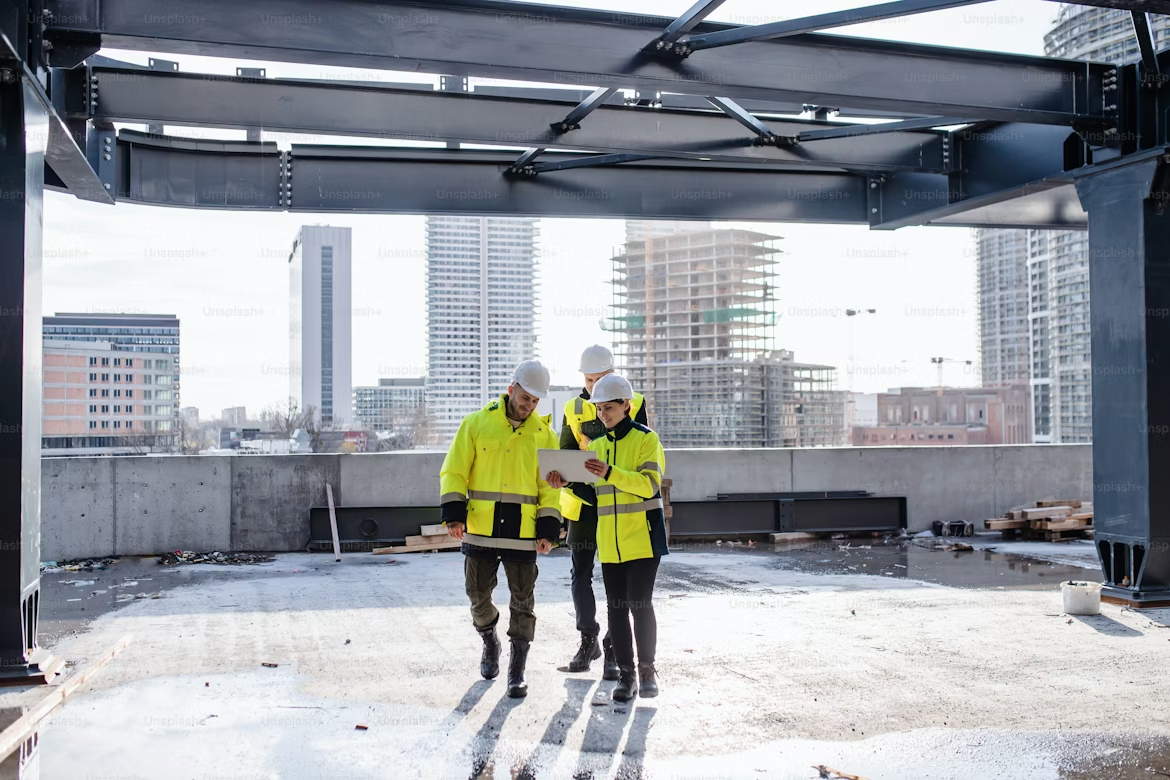 workers talking to each other on a rooftop