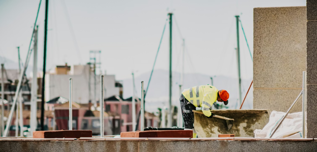 a man wearing protective gear working on top of a roof