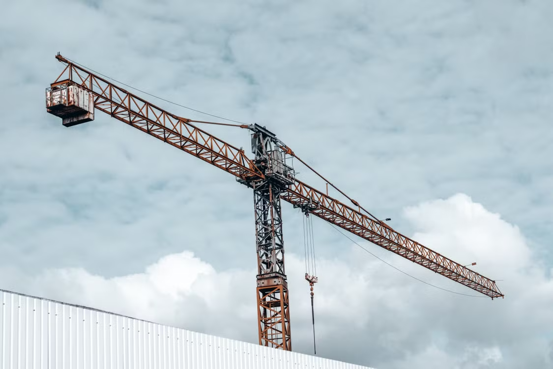 close-up of a crane being used for a commercial roof replacement