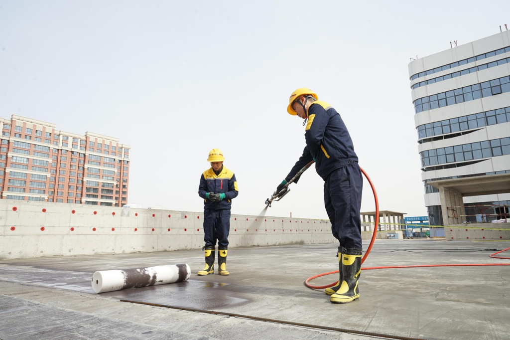 two workers working on a rooftop