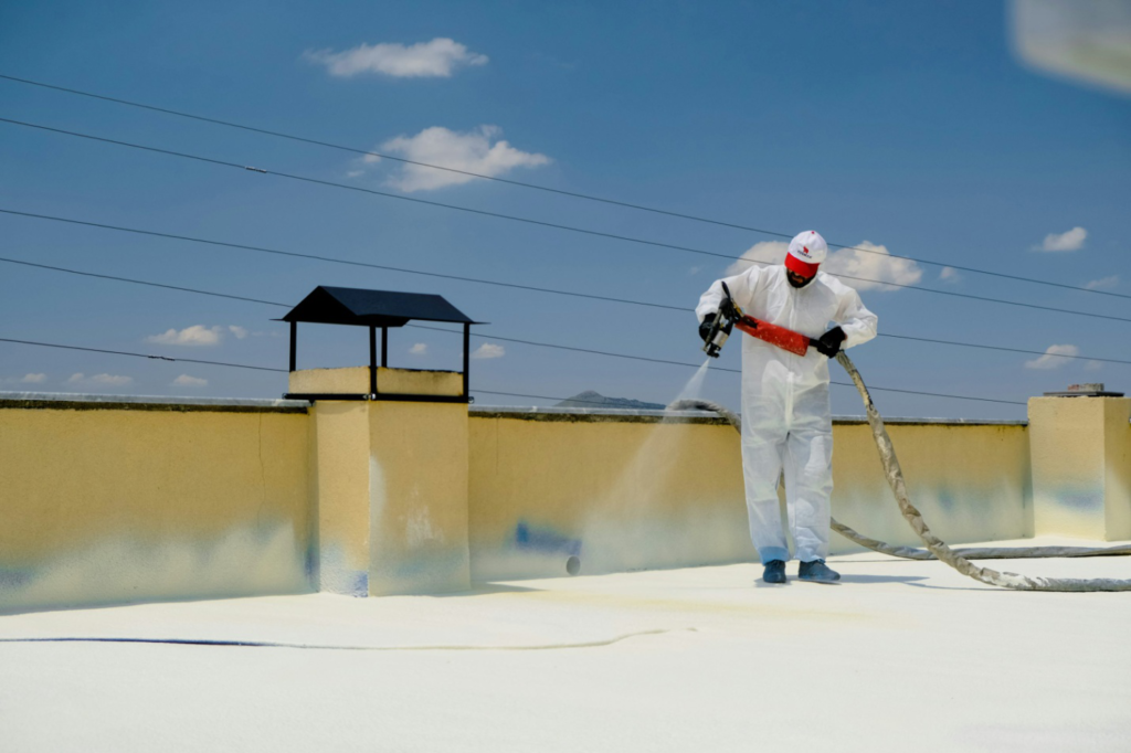 A worker coating a roof