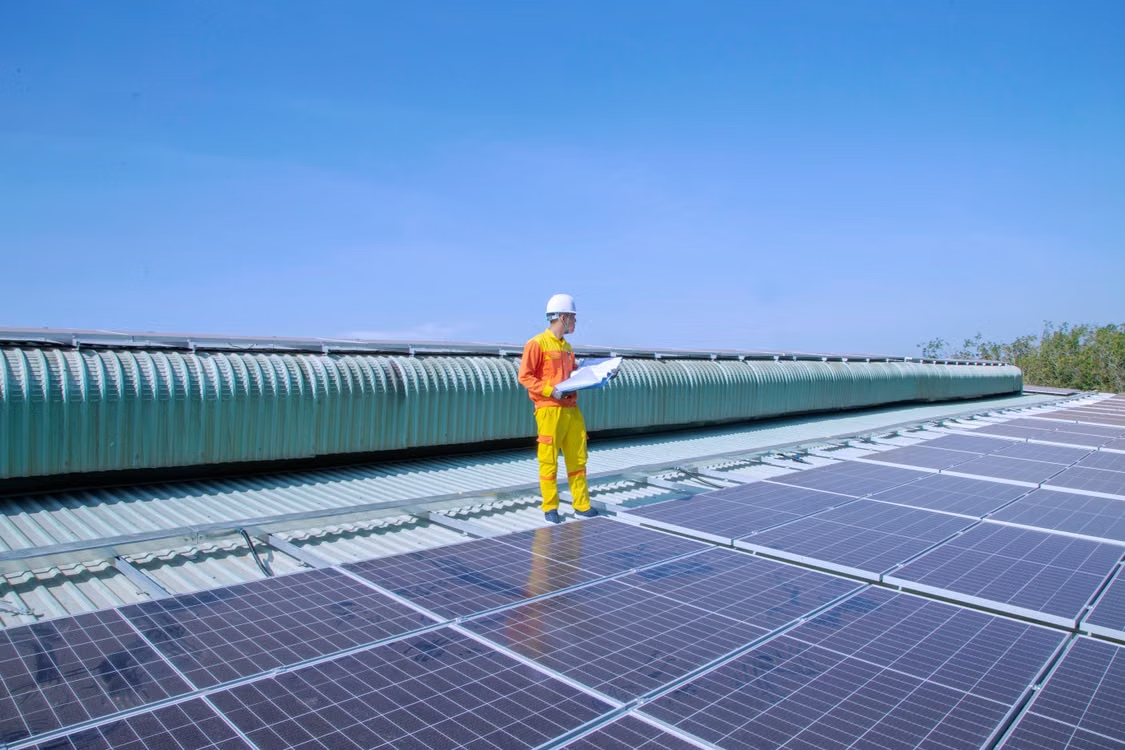 a worker inspecting a rooftop