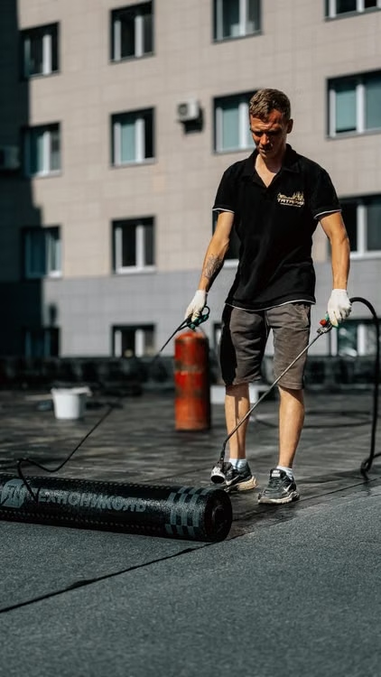 a technician servicing a roof