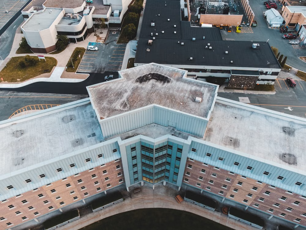 Drone view of the geometric rooftop of a commercial high-rise building.